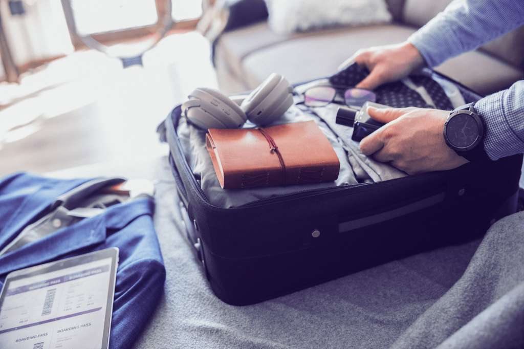 Man packing suitcase for travel