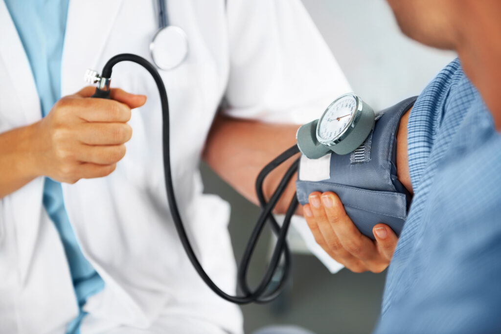 Primary Care Physician using stethoscope on patient