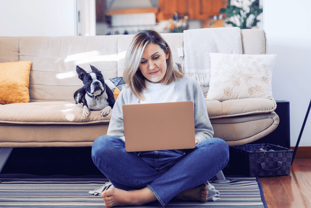 Woman sits on her computer at home.