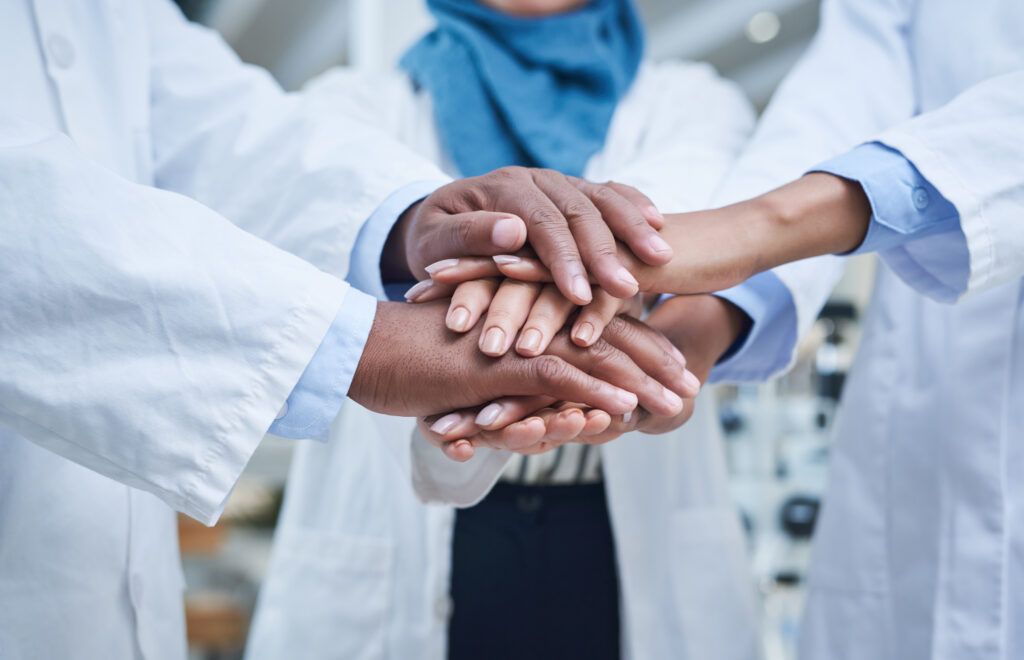 Doctors with hands together showing Strong Organizational Culture