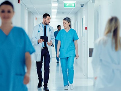 Nurse practitioners walk through hospital