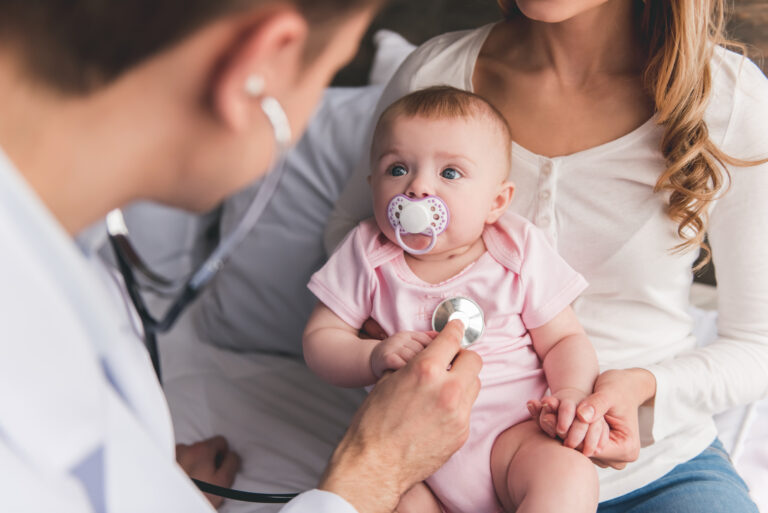 Pediatrician takes baby's heartbeat