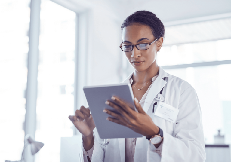 Female doctor uses tablet.