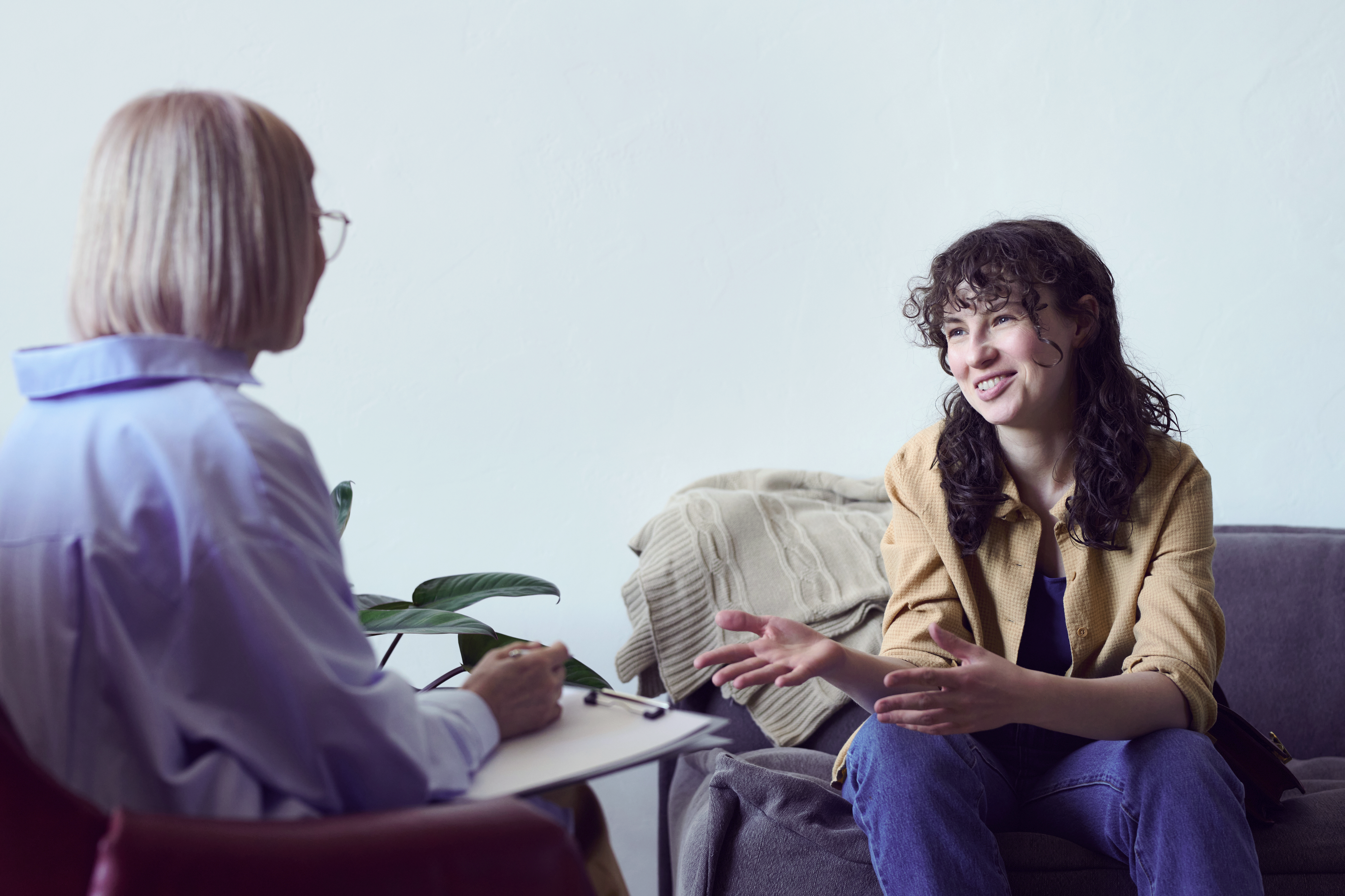 Young women in therapy session speaking to therapist