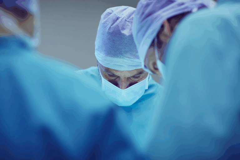 Group of three physicians performing surgery