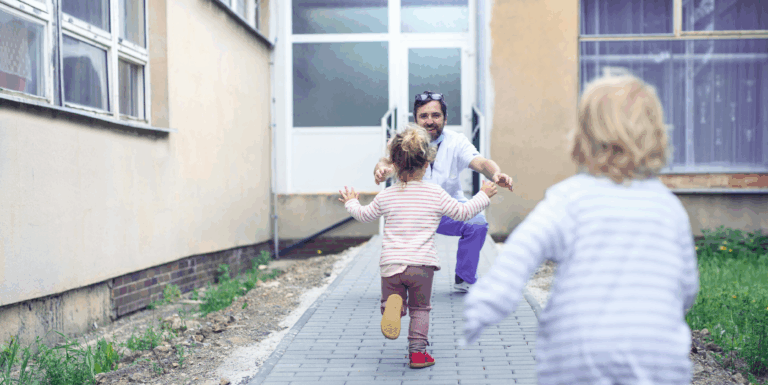 Children running to hug male doctor