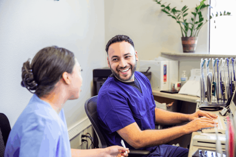 Healthcare providers having a conversation behind a desk.