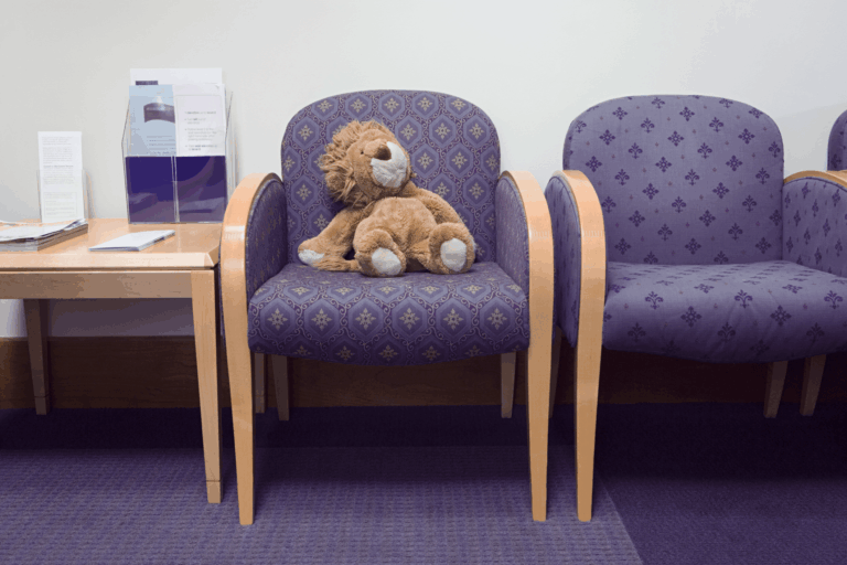 Stuffed animal sitting on chair in doctor's office waiting room