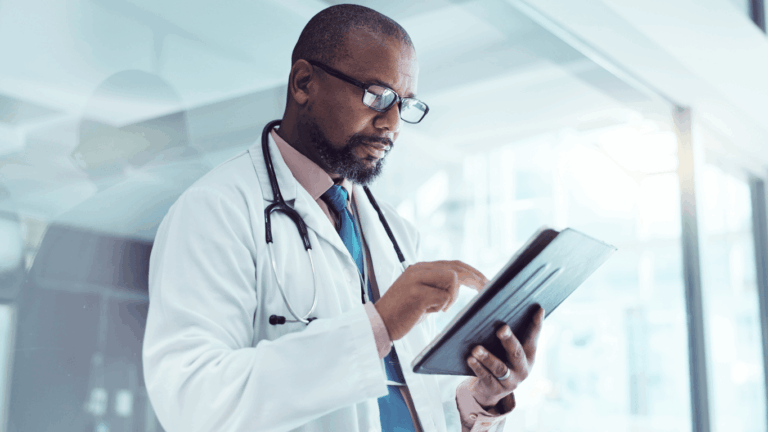 Male doctor using tablet