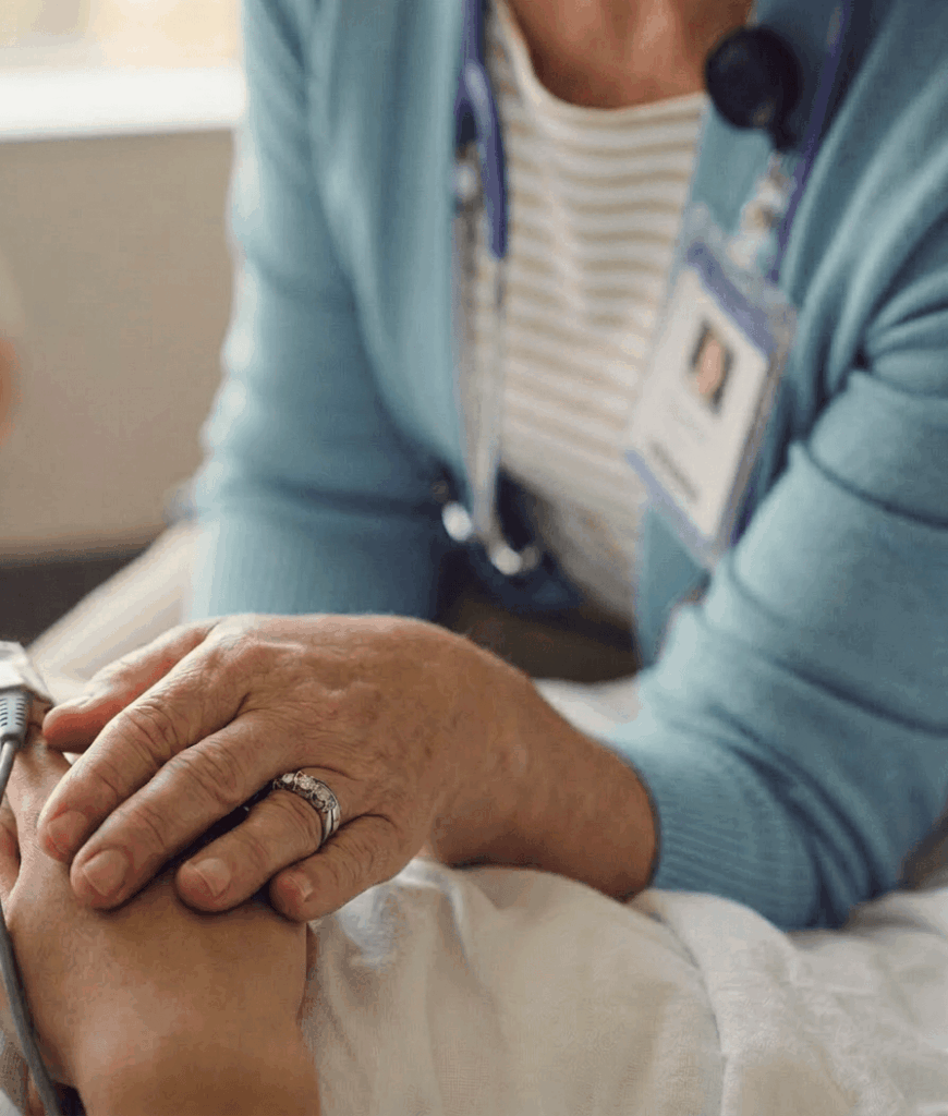 Female clinician holding patients hand