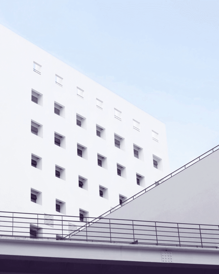 Exterior of multi-story hospital building with row of square windows